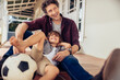 © Marko Geber - Father and son playing with soccer ball on porch