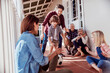 © Marko Geber - Multigenerational family playing soccer on house porch