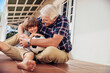 © Marko Geber - Grandfather and grandson playing with soccer ball on home porch