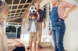 © Marko Geber - Grandparents and grandchildren having fun on home porch with football