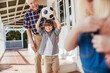 © Marko Geber - Grandfather and grandson playing with soccer ball on home porch