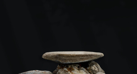 Wall Mural -  Rock Stone podium Isolated with light, shadow leaves on black wall background for Product Display, Grey Stack Rock Sea stone Shelf from beach concept for Zen,Spa,Cliff Rock natural stone with texture