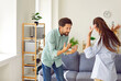 © Studio Romantic - Young couple man and woman standing at home and arguing shouting in quarrel. Angry unhappy husband and wife quarreling in the living room. Marriage problems, relationship and divorce concept.