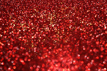 Wall Mural - Red glitter bokeh background with sparkling light, abstract defocused texture. Holiday lights