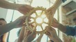 © VK Studio - Hands of a diverse group of people holding and connecting a golden gear with sunlight streaming through, symbolizing teamwork and innovative collaboration.