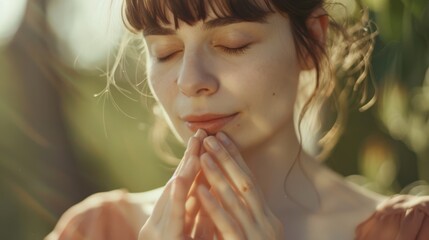 A serene woman with closed eyes, embracing the sunlight, exemplifying calmness, and mindfulness in a natural setting.