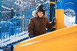 © alexkoral - happy child boy is playing on a playground on a slide outside in winter.