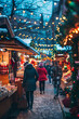 © Iriyalo - A festive Christmas market with decorated stalls and twinkling lights, as people browse through holiday goods