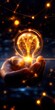 © Arnon  Parnnao - A glowing light bulb held in a hand, symbolizing ideas, innovation, and creativity in a modern, digital world.