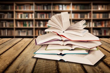 Canvas Print - pile of reading books on table in library, education