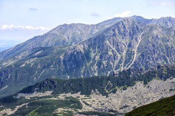 
Nature view with gray and green moss covered mountain peaks
