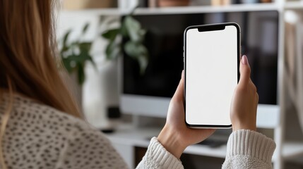 Poster - Woman holding phone showing blank white desktop screen for mockup