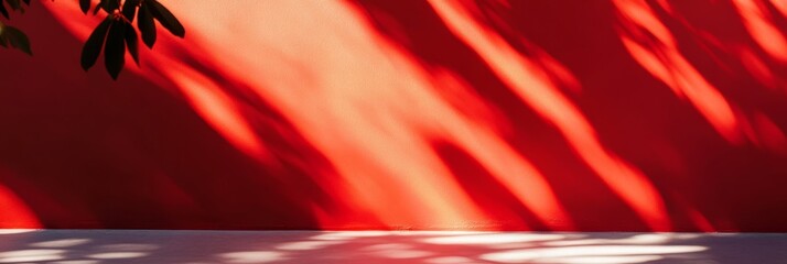 Poster - A stunning display of light and shadow on a vibrant red wall, showcasing natural beauty and contrast