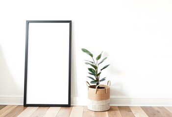 Wall Mural - A black picture frame on a white wall with a potted plant in the foreground