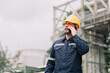 © ultramansk - professional man workers engineer in construction industry uses a smartphone to discuss project updates on site. the integration of technology and effective communication in construction management.