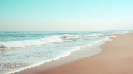 Wall Mural - Serene Beachscape: Tranquil blue waves gently lap against the sandy shore, creating a serene and picturesque landscape. 