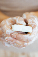 Poster - Closeup on young woman hands with soap