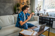 © Miljan Živković - Adult man enumerate, explain at video call meeting on laptop at home