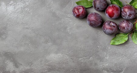 Wall Mural - Fresh plums on a gray background