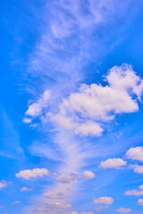 Wispy Clouds in Vibrant Blue Sky from Eye-Level Perspective