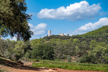 Poster - view on medieval tower and church on hills in the French Riviera back country in late summer