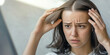 © SnowElf - A sad woman looks at her thinning hair. The problem of hair loss. Damaged Hair symptom