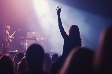 Wall Mural - A concertgoer enthusiastically reaches out during a performance as the artist captivates the audience with powerful music and vibrant lights