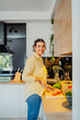 © Dusan - Young caucasian woman cutting vegetables in the kitchen