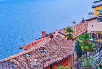 Poster - Flag of Lugano city and the old tile roofs in medieval village Gandria on the shore of Lake Lugano, Switzerland