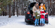 © Pixel-Shot - Happy family with car in forest on snowy winter day
