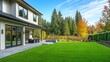 © Artyom - Modern house with lush green lawn, patio, and forest backdrop