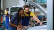 © DC Studio - Knowledgeable technician in repair shop showing client damages found inside car after inspection. Expert telling african american woman vehicle diagnostic after checking for defective parts