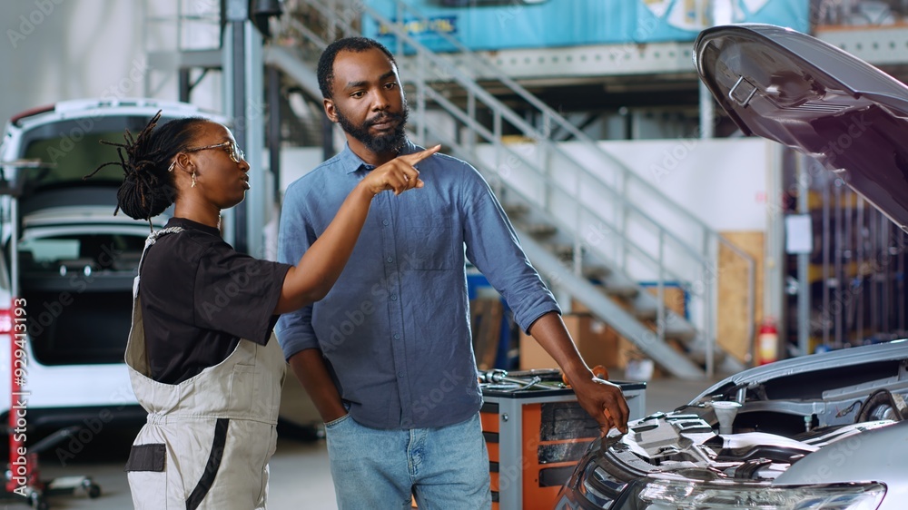 Mechanic in auto repair shop using augmented reality hologram to ...