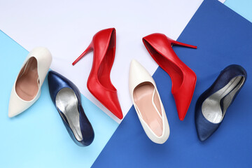 High-heeled female shoes on colorful background. Top view