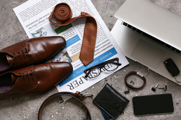 Wall Mural - Set of male accessories with laptop, shoes and tie on grey grunge background. Top view