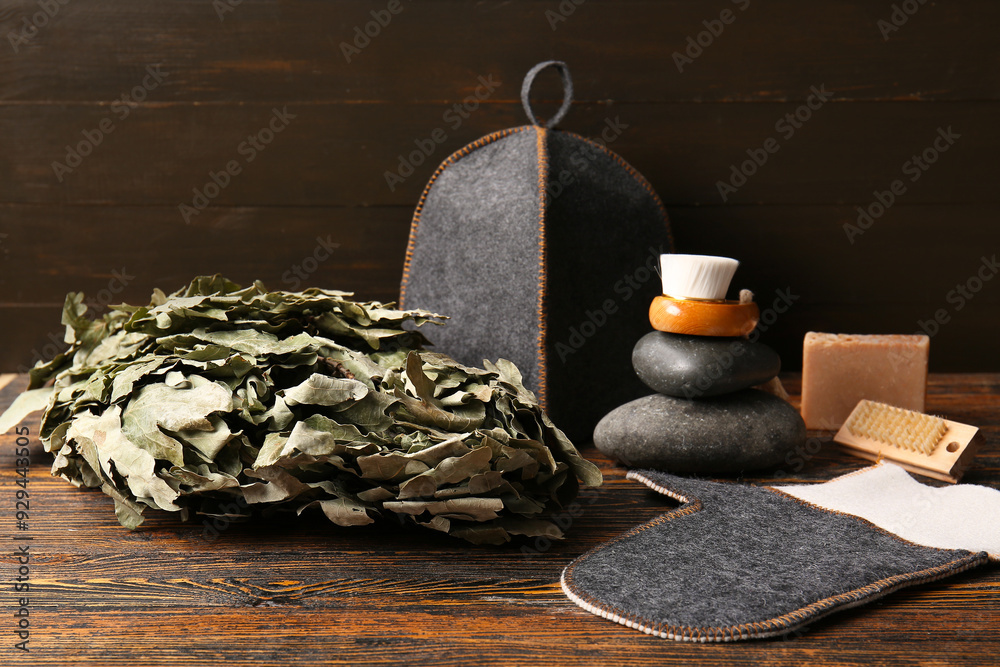 Set of different accessories for sauna on dark wooden background