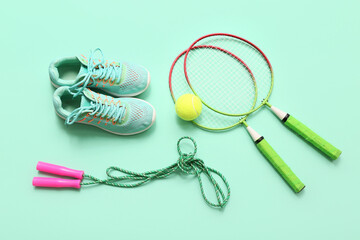 Wall Mural - Sneakers and sports equipment on turquoise background