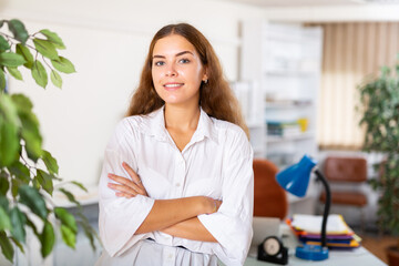 Wall Mural - Portrait of a young confident secretary girl in the office. Close-up portrait