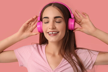 Wall Mural - Young woman in headphones with diastema on pink background, closeup