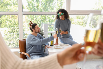 Wall Mural - Business colleagues with champagne celebrating New Year at party in office