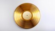 © Florence - a gold vinyl record lies flat on a white surface the record s grooves are visible and the label is white