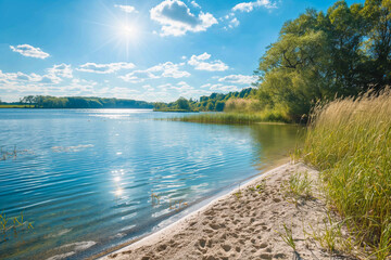 beautiful lake with a small beach and trees and beautiful green nature in the background in summer on vacation, generative AI