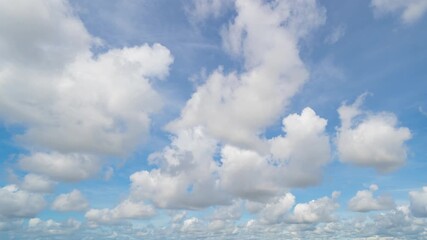Wall Mural - Time lapse of clear blue sky with white fluffy clouds at noon. Day time. Abstract nature landscape background.