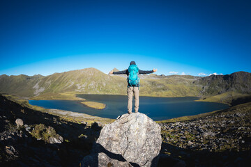 Wall Mural - Hiking woman on high altitude mountain top