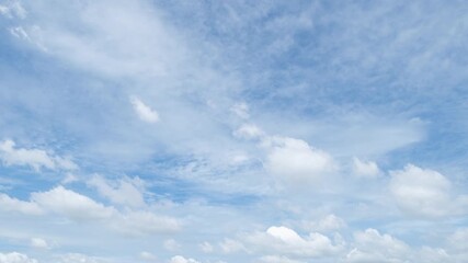 Wall Mural - Time lapse of clear blue sky with white fluffy clouds at noon. Day time. Abstract nature landscape background.
