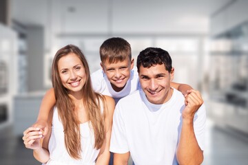 Poster - Happy young family having breakfast in kitchen