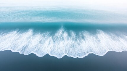 A large wave crashing onto a beach