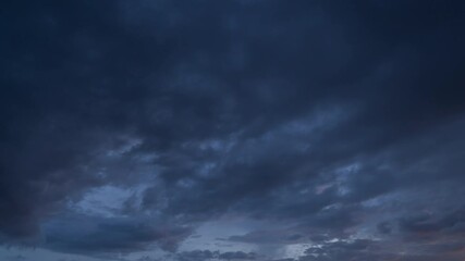 Wall Mural - Time lapse of sunset sky. Abstract nature background. Dramatic blue with orange colorful clouds in twilight time.
