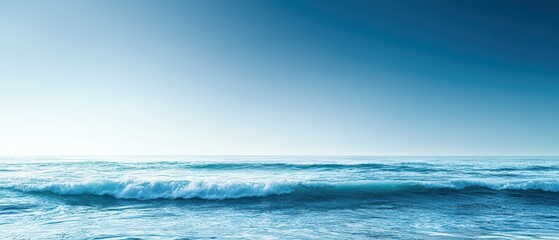 Wall Mural - A tranquil blue ocean scene with soft waves and a clear sky