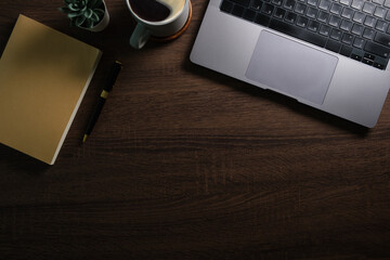 Wall Mural - Top view laptop, notebook and coffee cup on wooden table, copy space for your text.